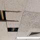 broken acoustic tiles in a drop ceiling